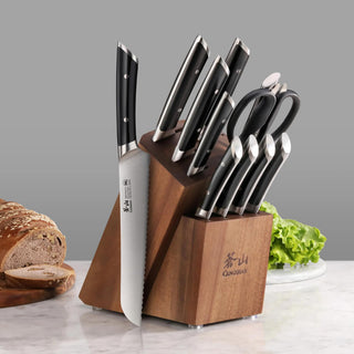 
                    
                      12-piece knife set with black handles in a wooden block, including a bread knife, scissors, and various kitchen knives.
                    
                  