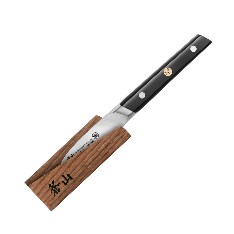 Japanese paring knife with black handle resting on a wooden sheath with Japanese characters.