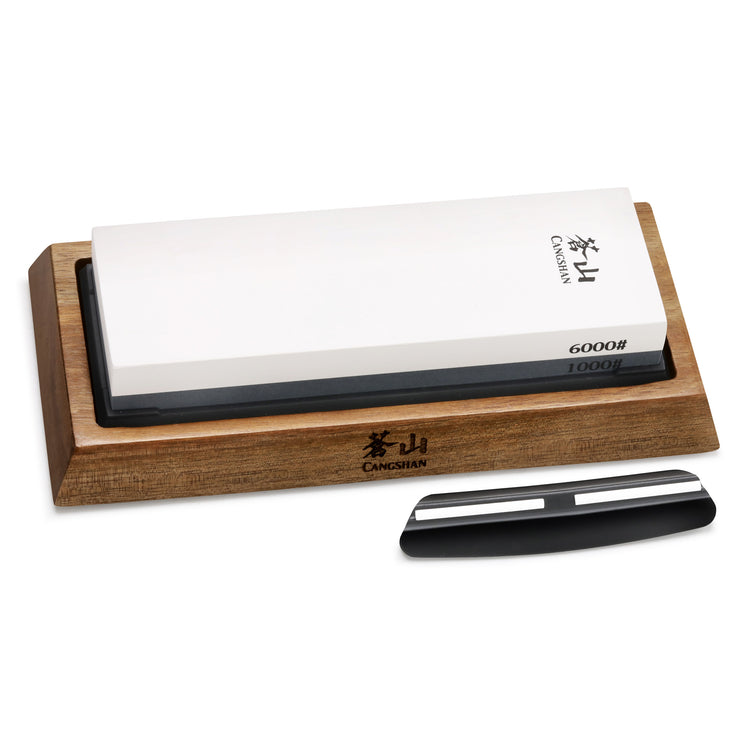 Dual-sided whetstone with 1000 and 6000 grit on a wooden base, accompanied by a black knife angle guide.