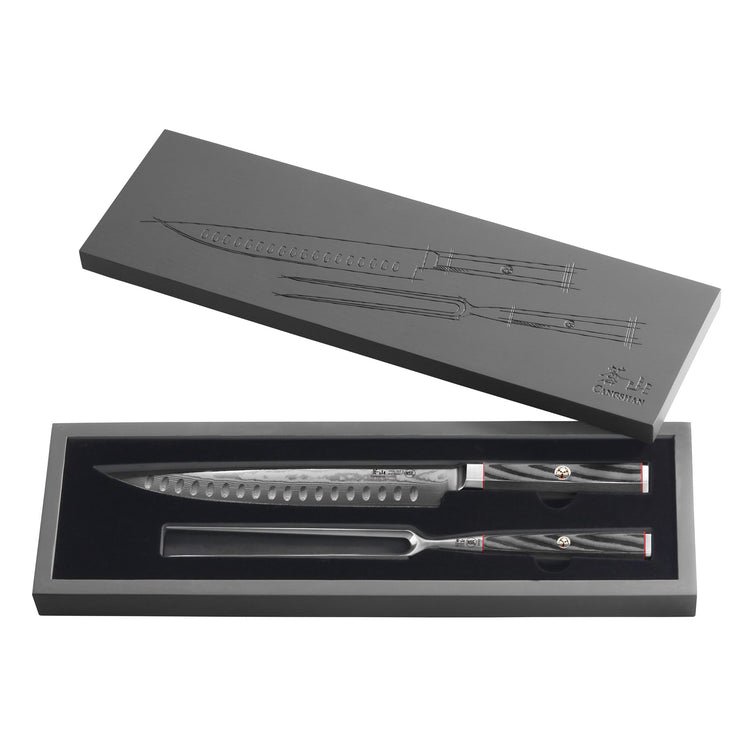 Two-piece carving set with patterned steel blades and dark textured handles in a black presentation box.