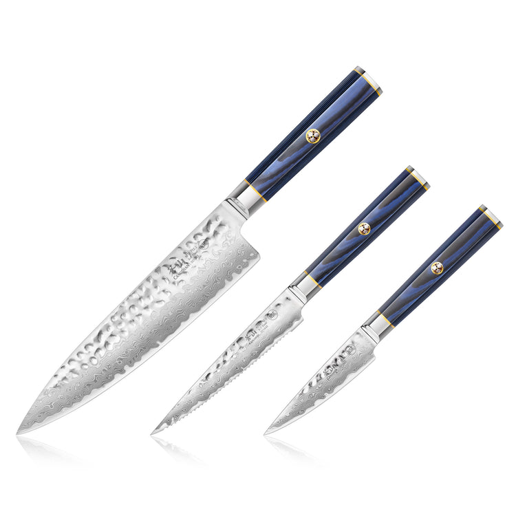 Three kitchen knives with hammered Damascus steel blades and blue handles with gold accents, arranged side by side.