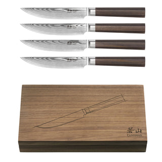 
                    
                      Four steak knives with patterned steel blades and wooden handles, displayed above a wooden storage box with a knife illustrat
                    
                  