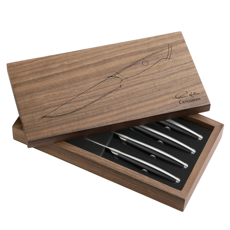 Four black-handled steak knives in a walnut storage box with a knife illustration on the lid.