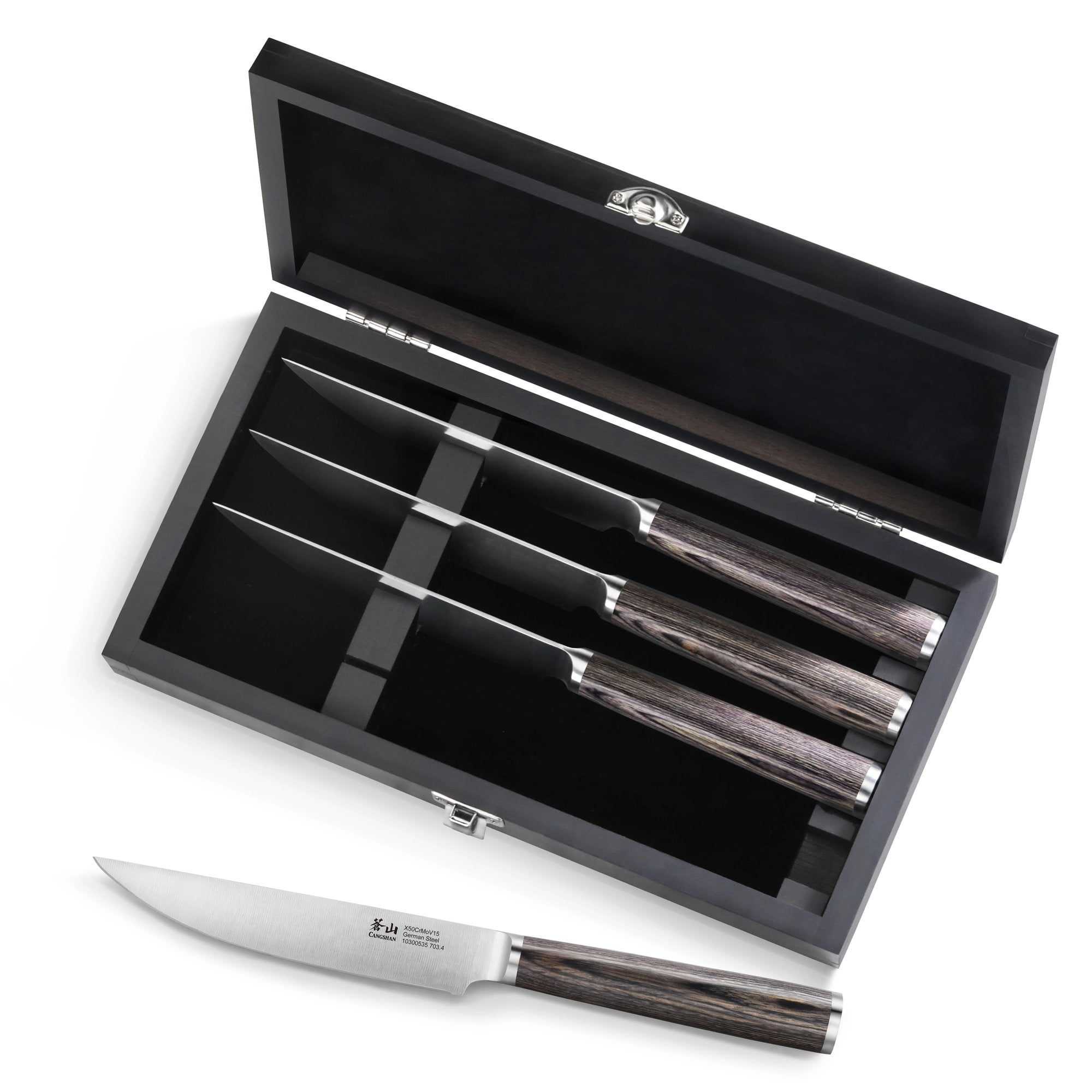 Four steak knives with pakkawood handles in a black wood box, one knife placed outside the box.
