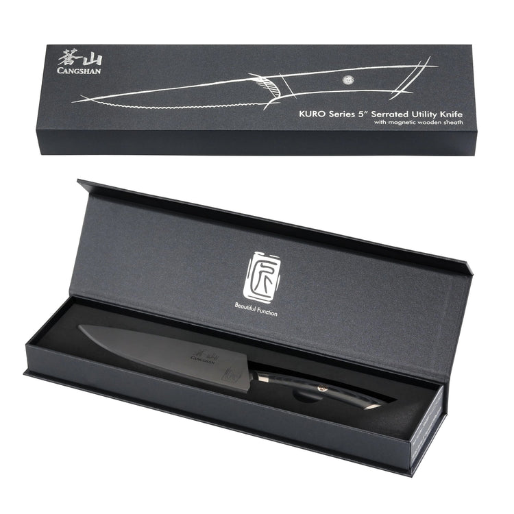 KURO Series 5-inch serrated utility knife with black handle and sheath, displayed in an open black presentation box.