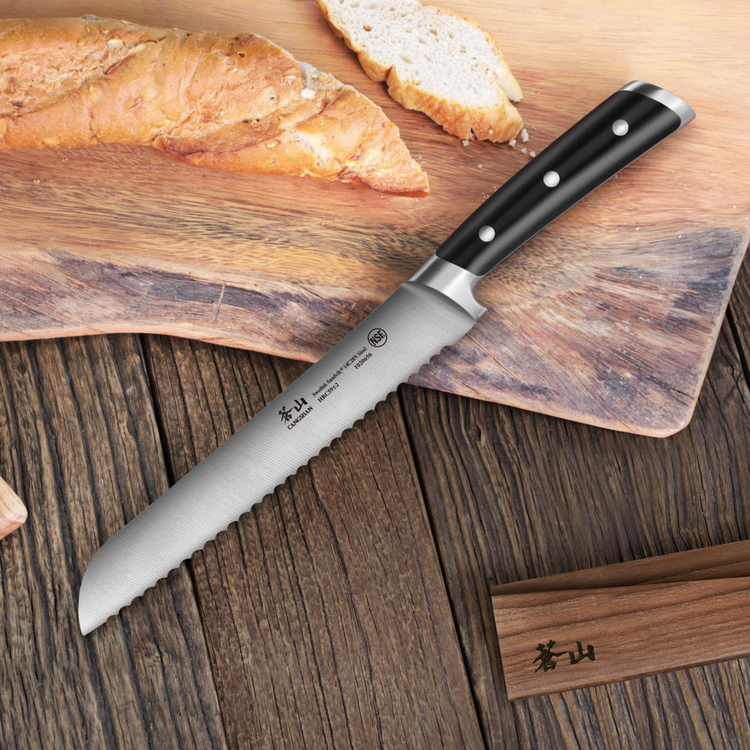 TS Series 8-inch serrated bread knife with black handle on wooden surface next to sliced bread and wood sheath.