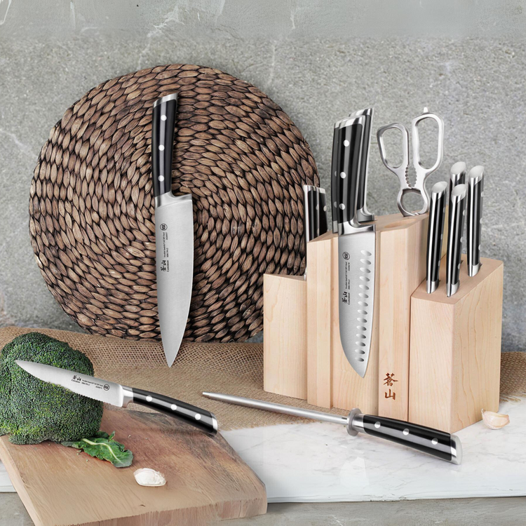 Magnetic knife block set with various knives, kitchen shears, and sharpening steel on a countertop.