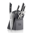 Six-piece knife set with patterned blades, black handles, scissors, and a black angled block with "CANGSHAN" logo.