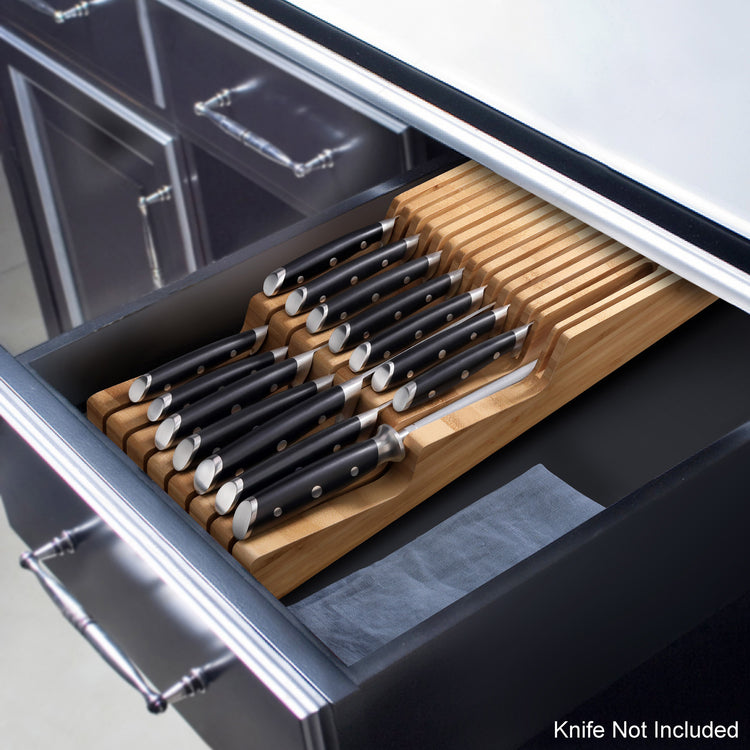 Bamboo knife organizer with 15 slots holding black-handled knives inside a kitchen drawer.