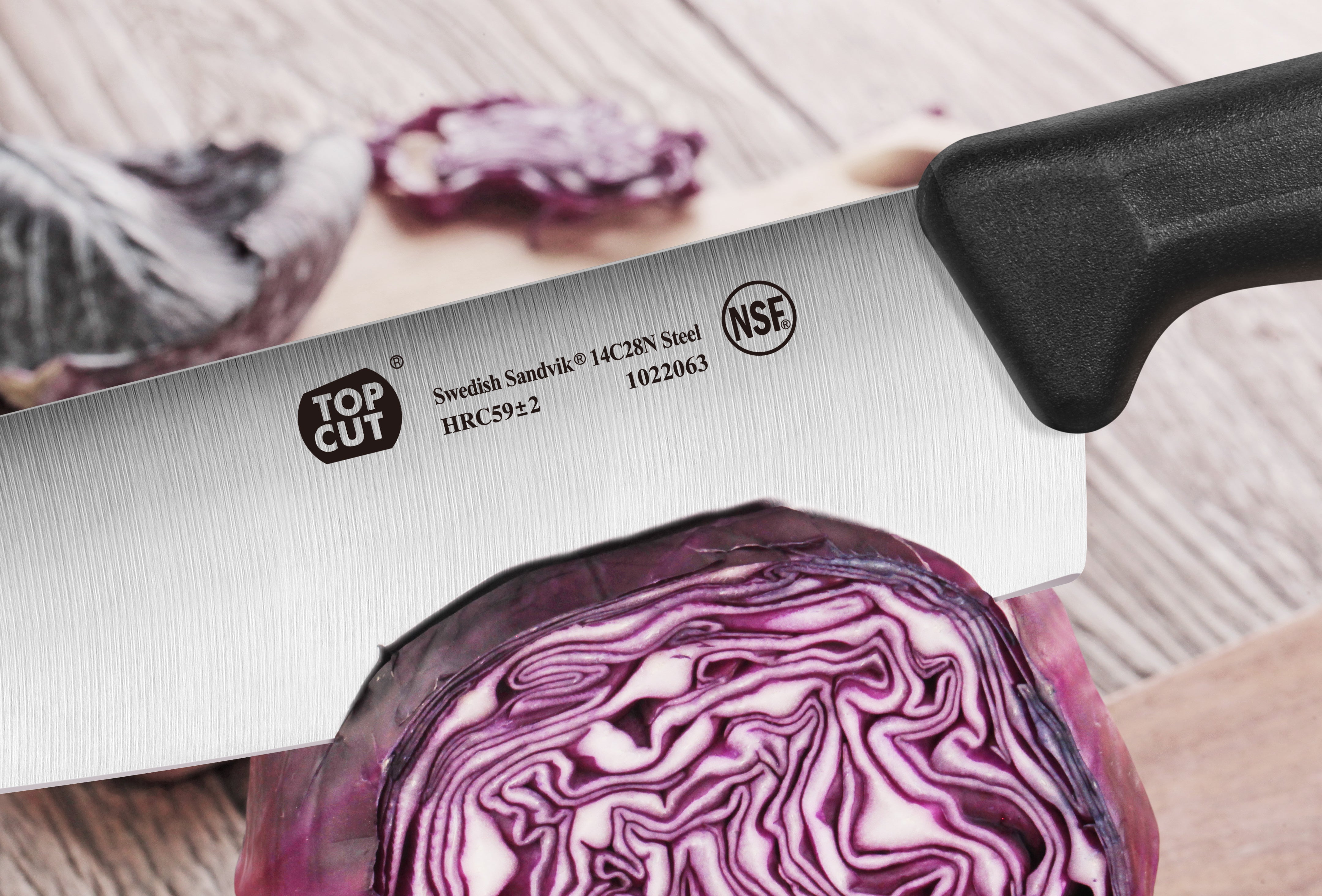 7-inch Nakiri vegetable cleaver with black handle slicing a halved purple cabbage on a wooden surface.