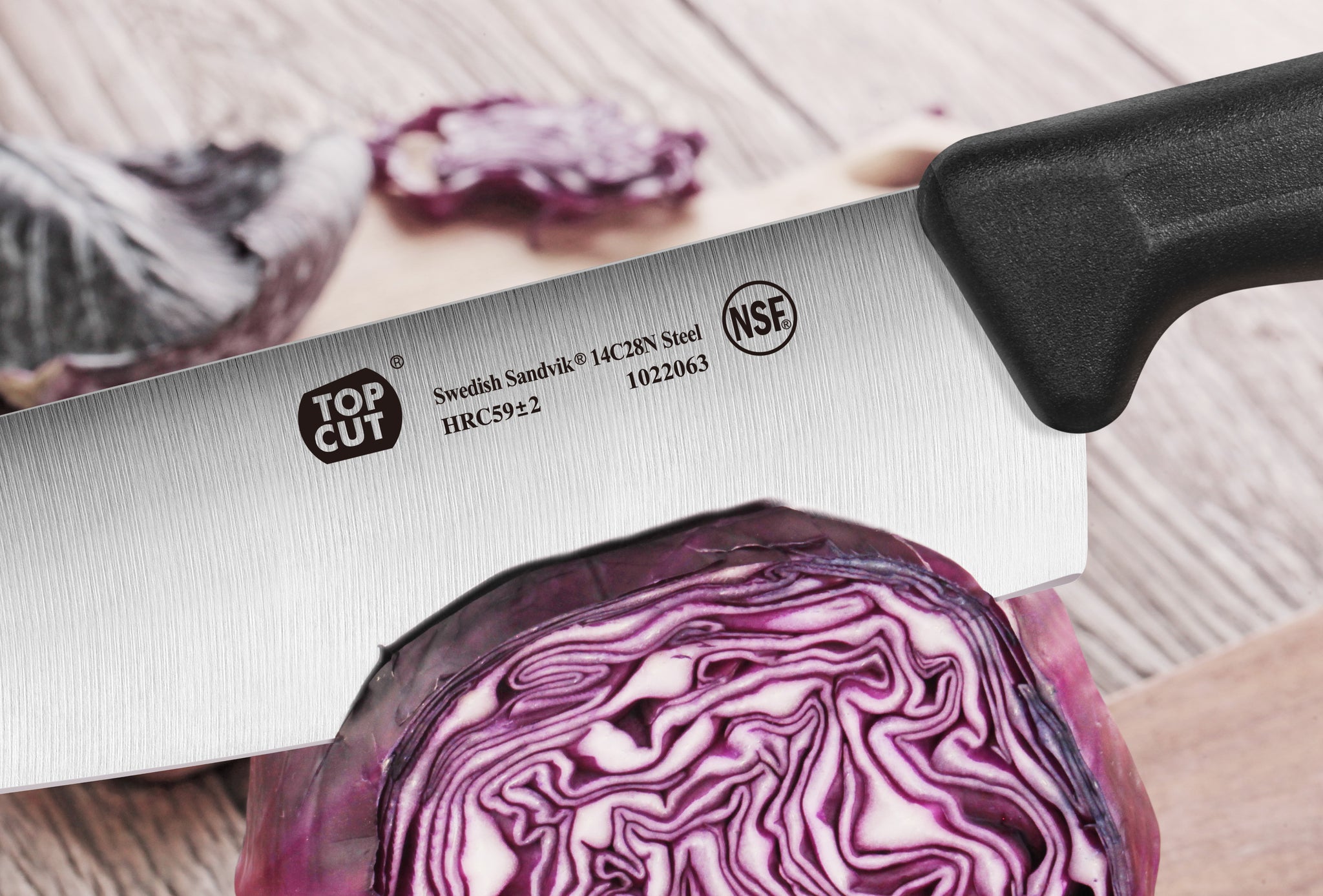 7-inch Nakiri vegetable cleaver with black handle slicing a halved purple cabbage on a wooden surface.