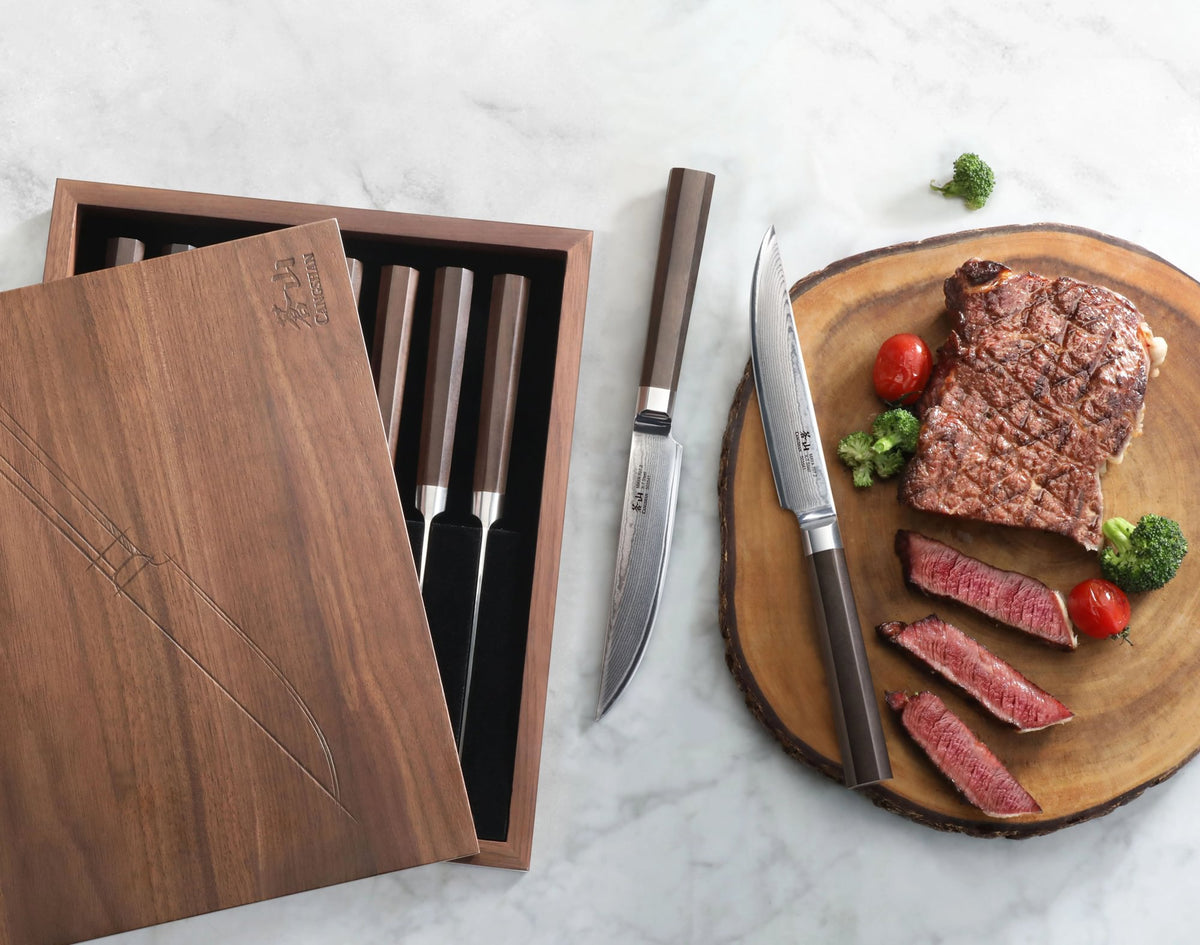 MAYA Series 8-Piece Steak Knife Set in X-7 Damascus Steel with a walnut box and sliced steak on a cutting board.