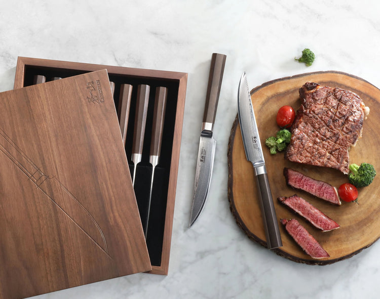 MAYA Series 8-Piece Steak Knife Set in X-7 Damascus Steel with a walnut box and sliced steak on a cutting board.