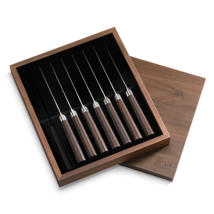 MAYA Series 8-piece steak knife set with dark wood handles, displayed in an open walnut box.