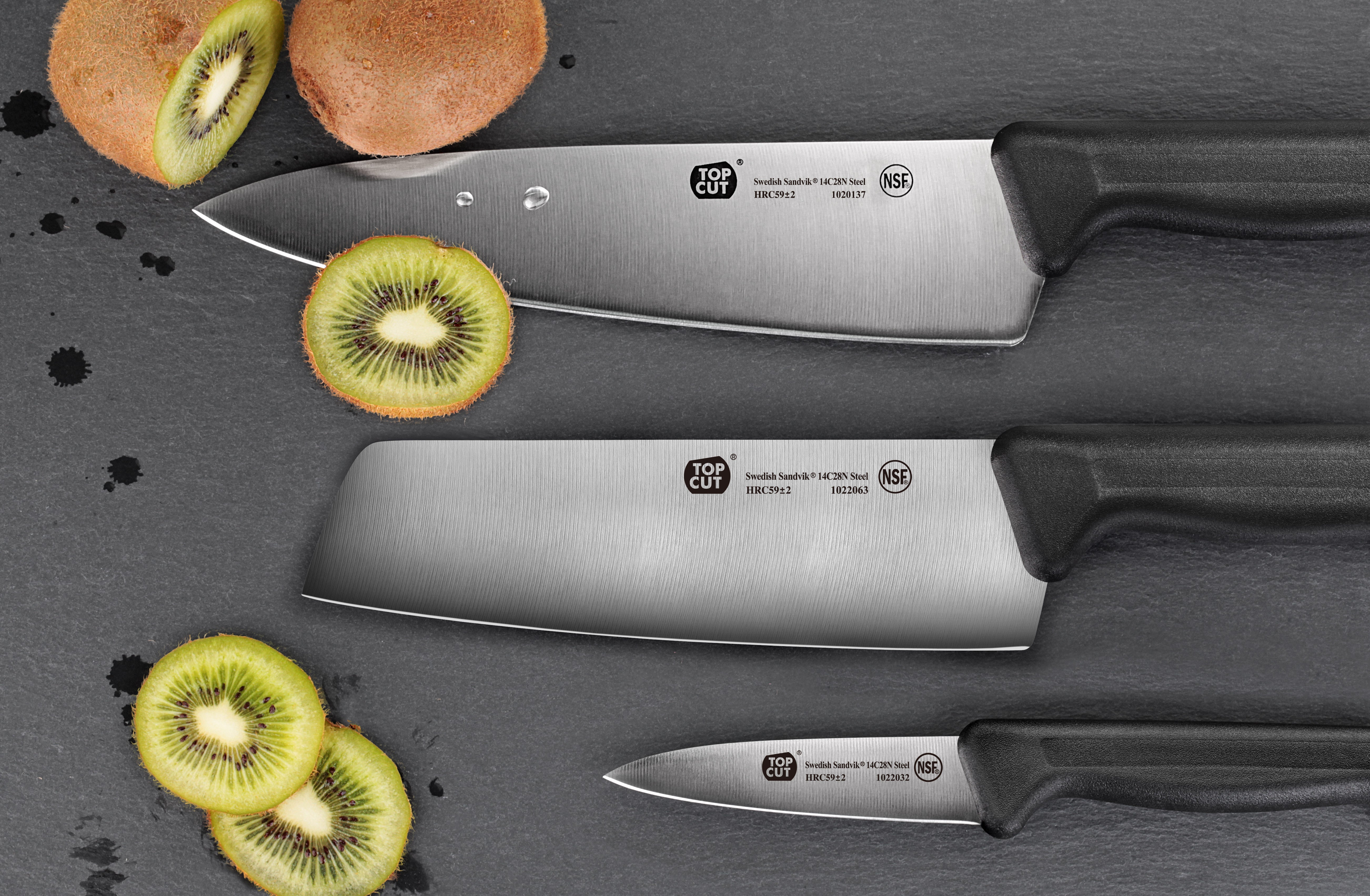 Three Top Cut knives with black handles on a dark surface, alongside sliced and whole kiwis.