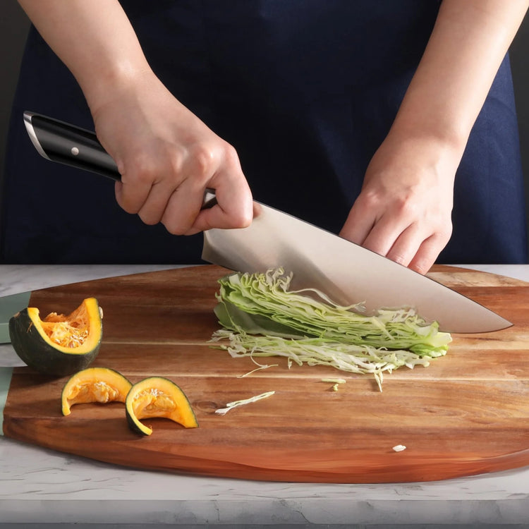 Hands slicing shredded cabbage on a wooden cutting board next to cut pieces of squash.