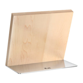 
                    
                      Rectangular wooden knife block with a slanted top edge on a flat metal base.
                    
                  