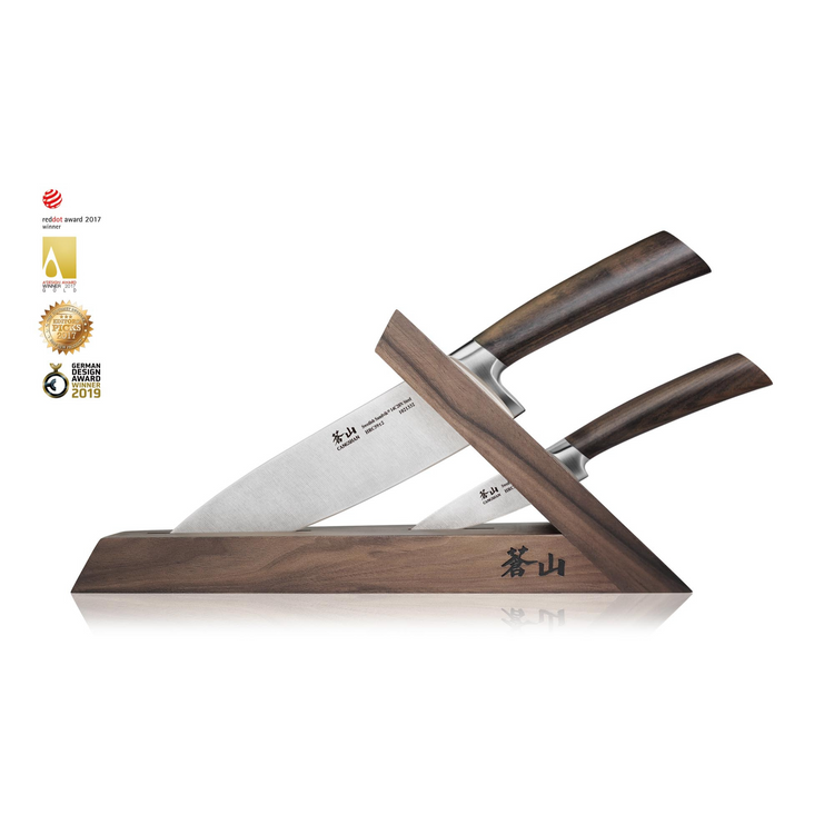 Two knives with wooden handles in a walnut angled wooden block with engraved characters.