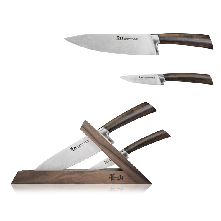 Three kitchen knives with forged steel blades and walnut handles displayed with a matching walnut knife block.