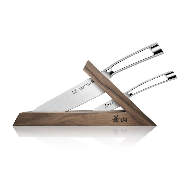 Two stainless steel knives with hollow handles in a triangular walnut wooden block with Japanese characters.
