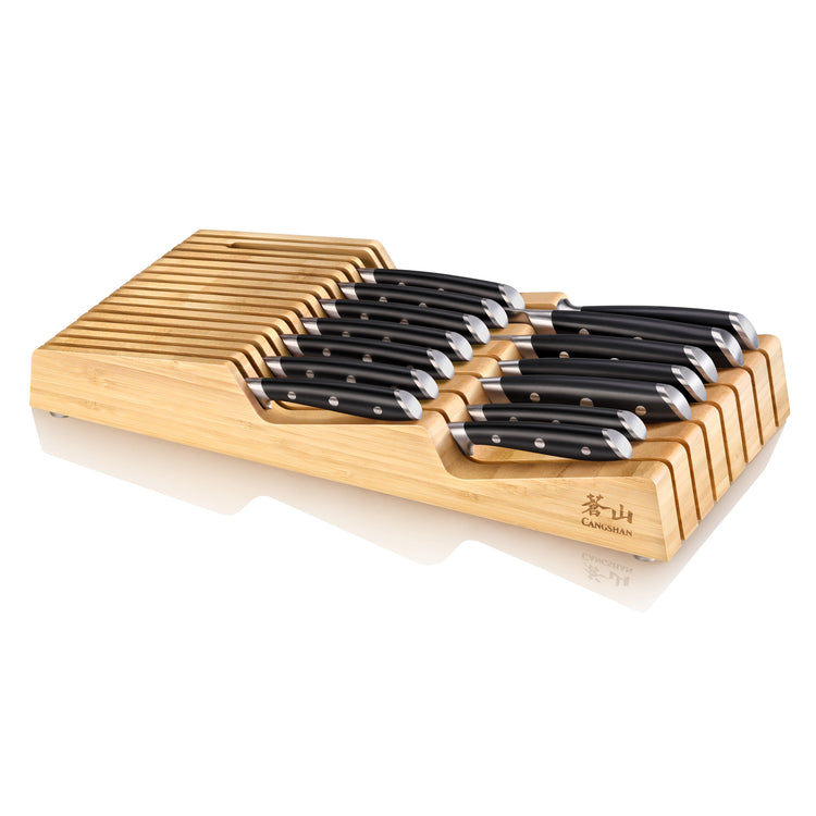 15-piece knife set with black handles arranged in a bamboo in-drawer tray with slots for each knife.