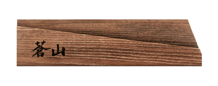 Solid ash wood magnetic knife sheath with angled groove and black engraved characters on one end.