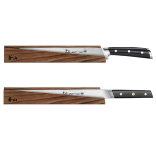 
                    
                      Two long, slender kitchen knives with black handles resting on solid ash wood magnetic sheaths.
                    
                  