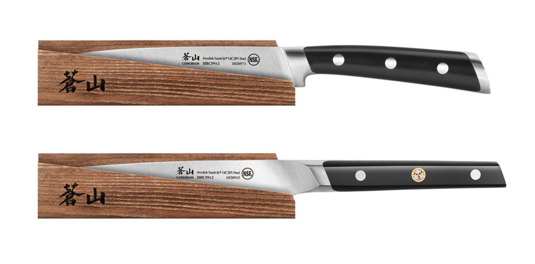 Two kitchen knives with black handles resting on solid ash wood magnetic sheaths with Japanese characters.