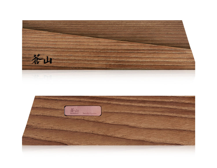 Solid ash wood magnetic knife sheath with engraved logo and metal label on smooth wooden surface.