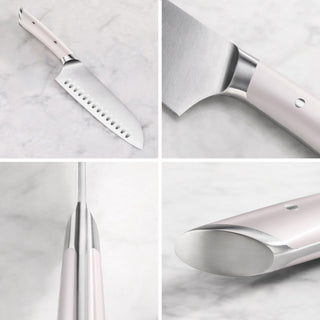 
                    
                      Santoku knife with white handle and stainless steel blade shown from multiple close-up angles on a marble surface.
                    
                  