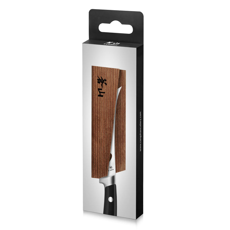 Solid ash wood magnetic knife sheath covering a kitchen knife blade in black and white packaging.