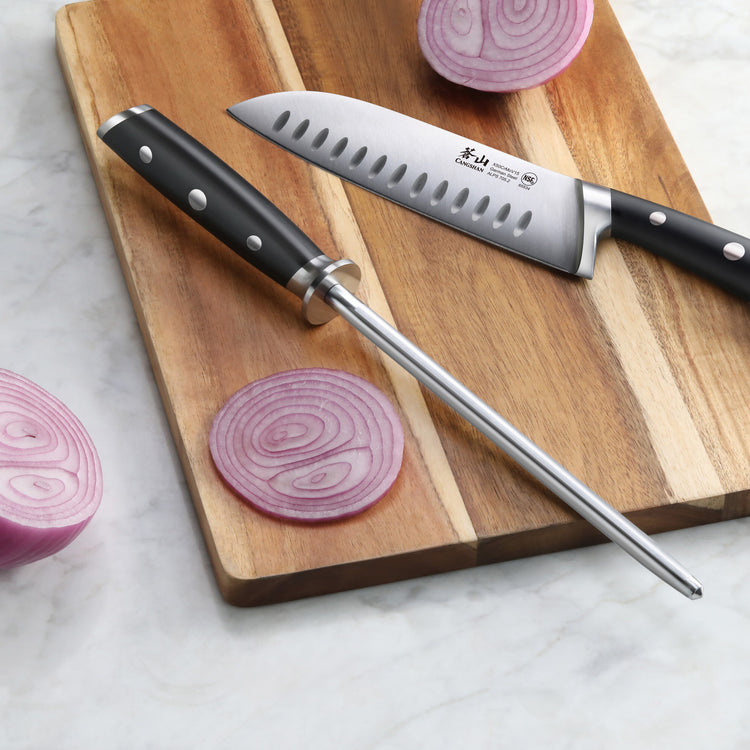 8-inch honing steel with black handle and chef's knife on wooden cutting board with sliced red onions.