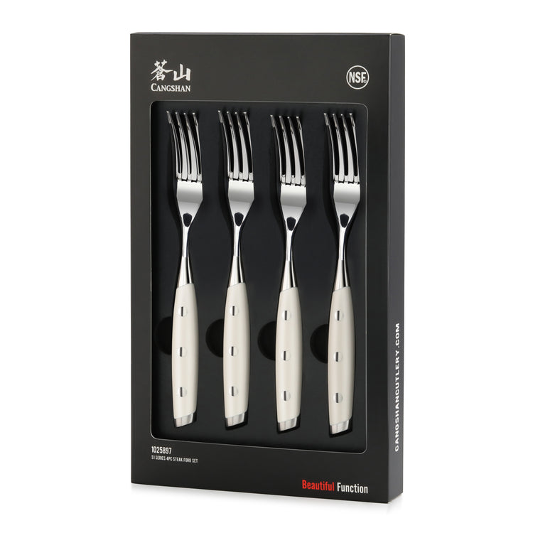 Four stainless steel steak forks with white handles arranged in black packaging box.
