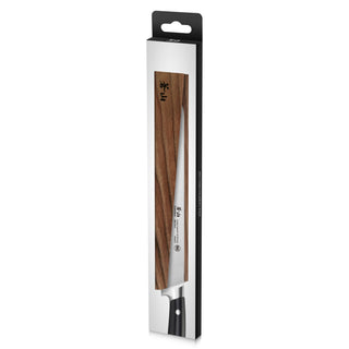 
                    
                      Magnetic knife sheath made of solid ash wood covering a kitchen knife blade in retail packaging.
                    
                  