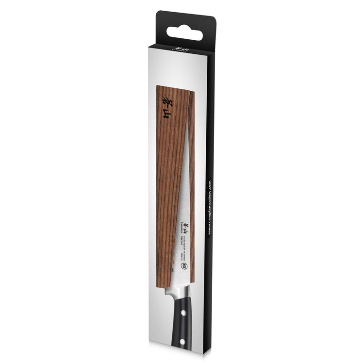 Solid ash wood magnetic knife sheath covering the blade of a kitchen knife with a black handle in retail packaging.