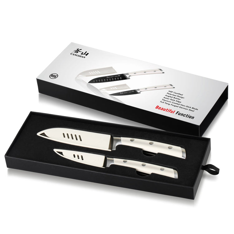 Set of two stainless steel kitchen knives with white handles in a black presentation box and packaging.