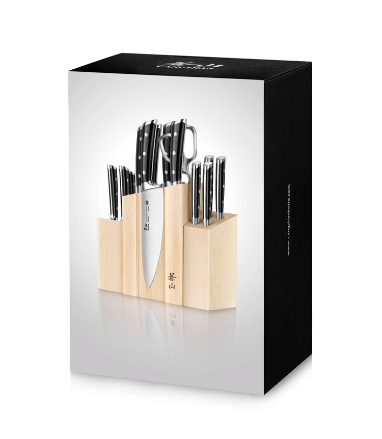 Knife block set with multiple stainless steel knives and kitchen scissors in a light wood block.