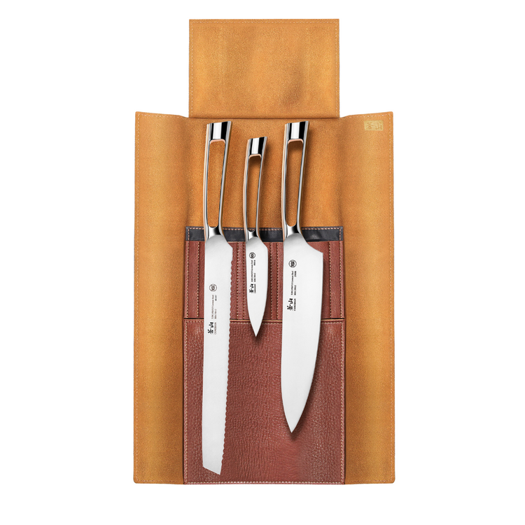 Four stainless steel knives with polished handles in a brown leather roll-up case with tan flap.