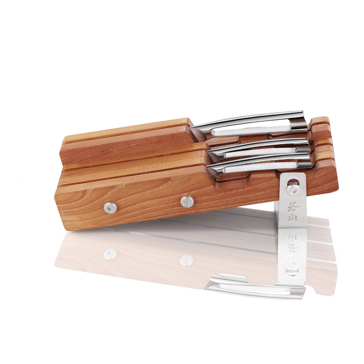 Wooden knife block holding four knives with stainless steel handles, displayed on its side with a metal stand.