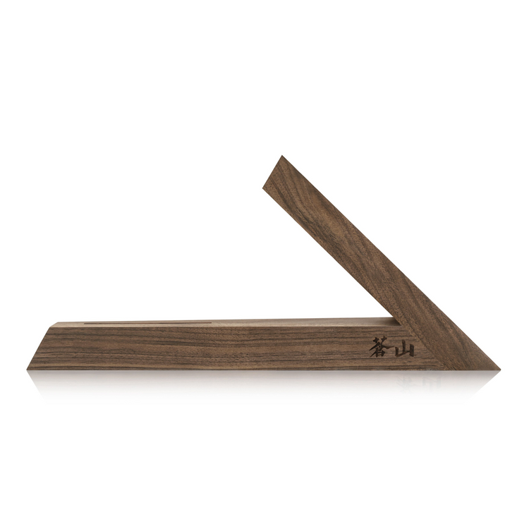 Walnut wood knife block with a triangular design and engraved characters on the base.