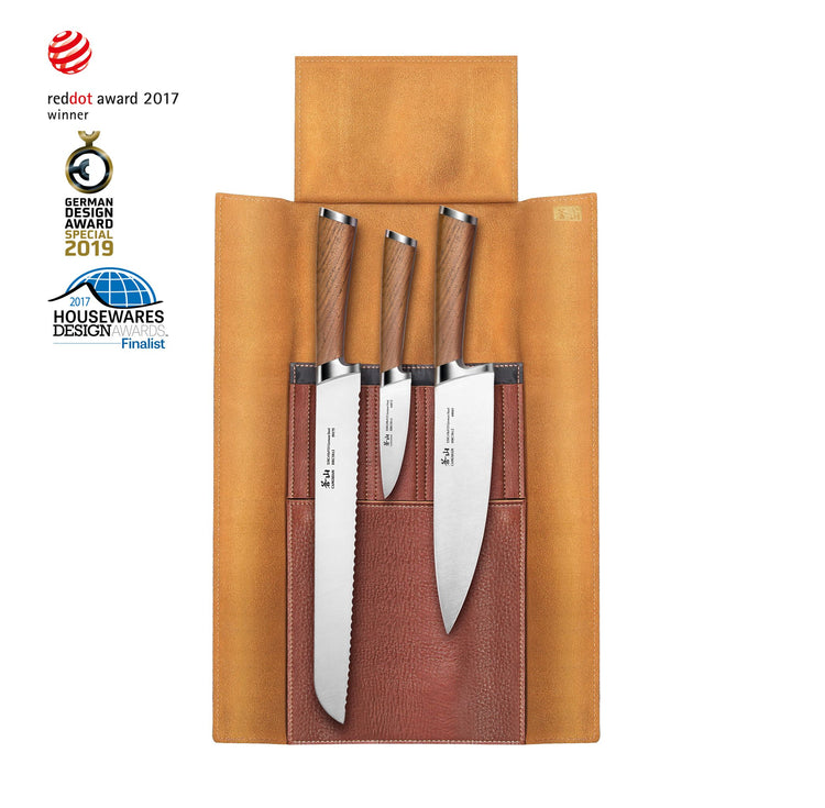Four knives with wooden handles in a brown leather roll-up case, arranged vertically with blades facing down.