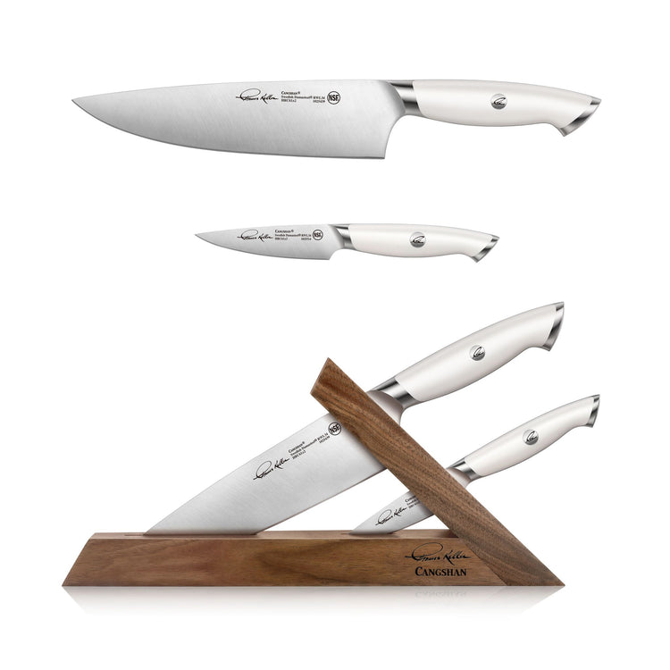 Two white-handled knives, one chef's and one paring, displayed with a walnut triangular knife block on a white background.