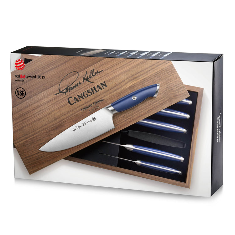 Wooden box with six blue-handled knives arranged inside, one knife resting on the box lid with signature engraving on the bla