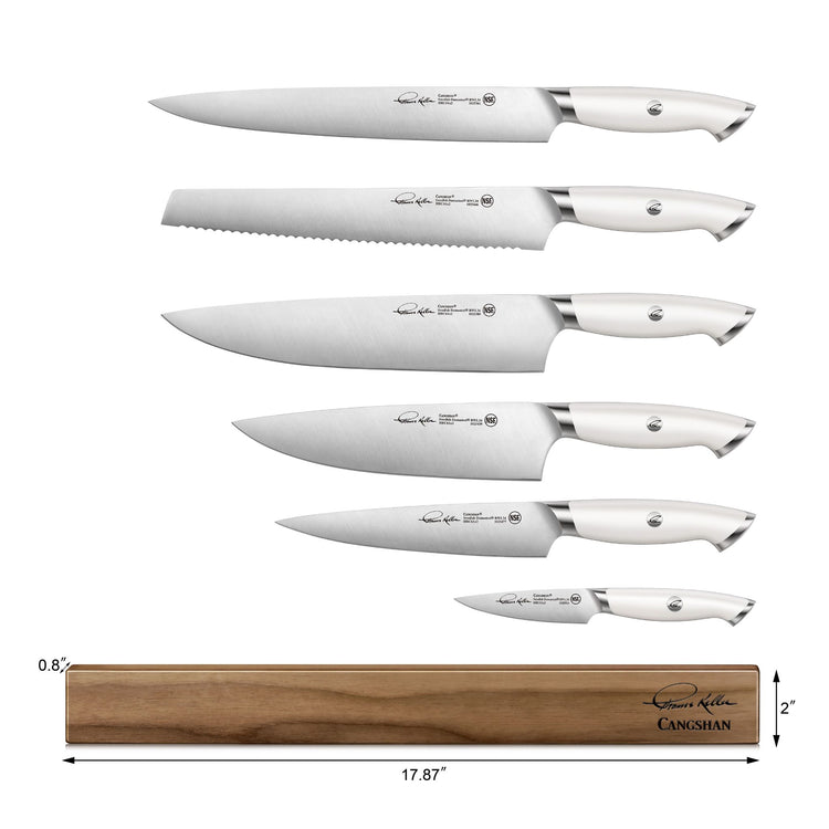 Six stainless steel knives with white handles arranged above a wooden magnetic knife bar measuring 17.87 by 2 inches.